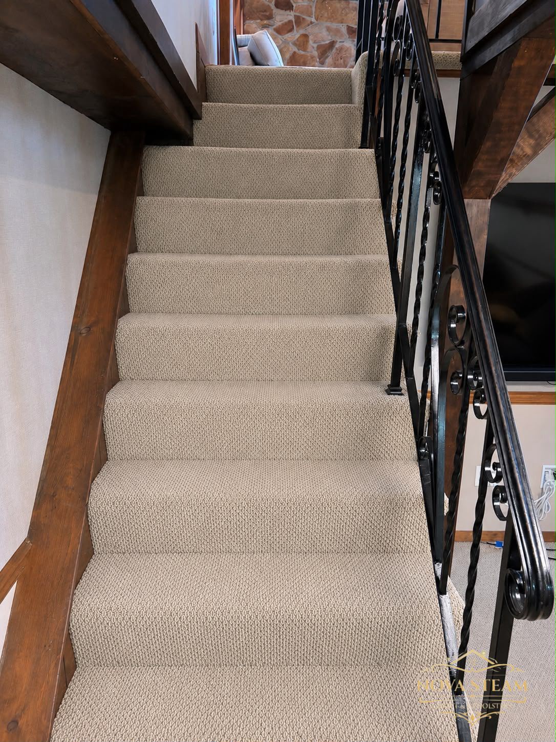 The same staircase after steam extraction, restored to an even, light tan finish
